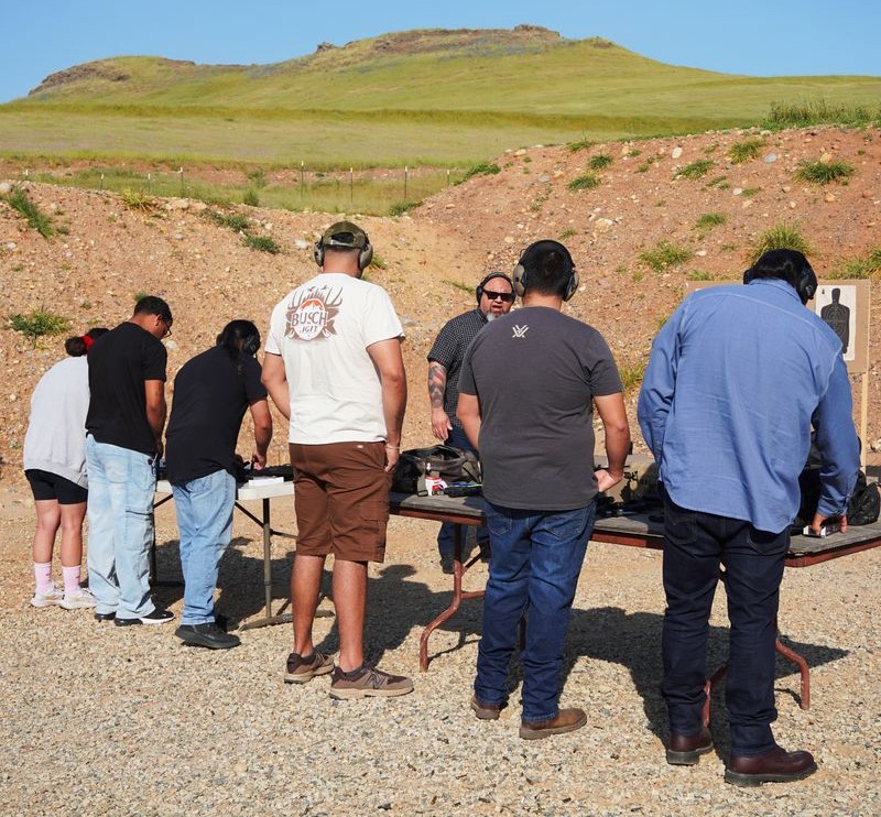 Group of students lined up during outdoor CCW live-fire training at a California shooting range with 559CCW instructor supervision
