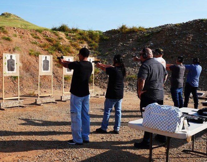 Students participating in live-fire CCW training at an outdoor shooting range in California with 559CCW instructor guidance